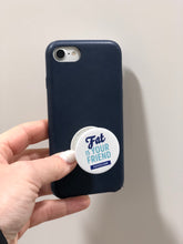 FATCO Fat is Your Friend Pop Socket phone holder and stand attached onto a mobile cell phone